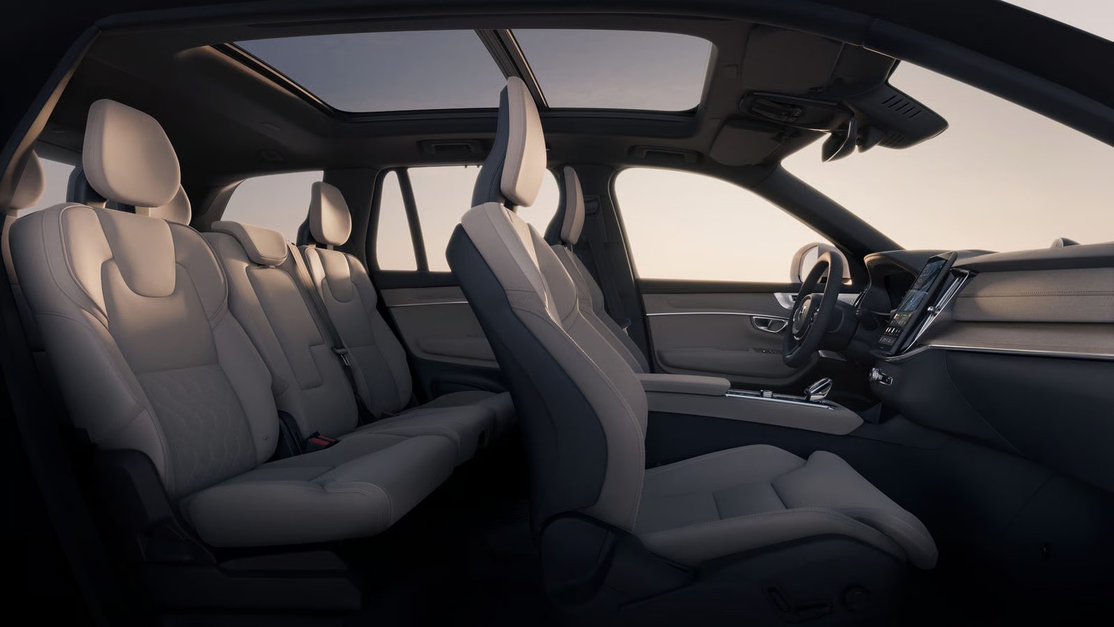 2026 Volvo XC90 interior showing the second-row captain's chairs, front seats and driver display
